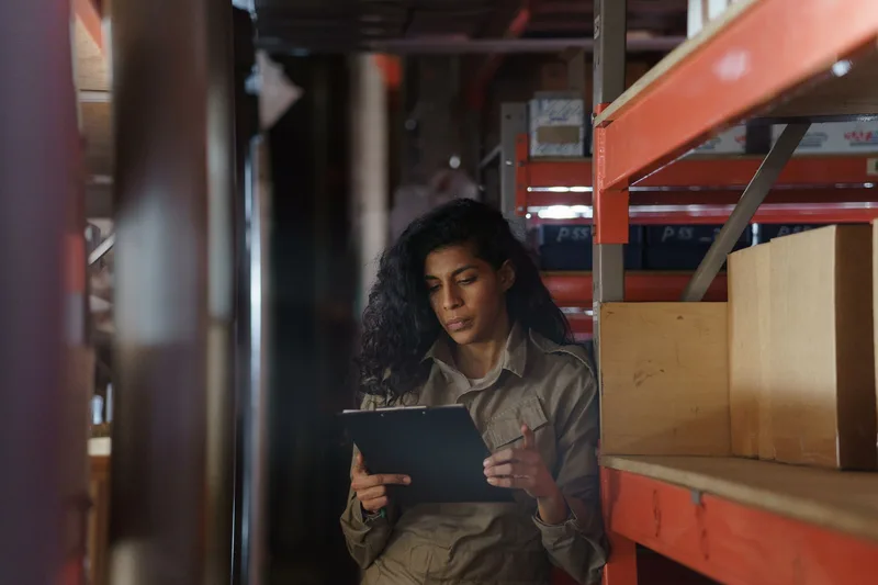 A warehouse worker checking inventory boxes for an FBA shipment
