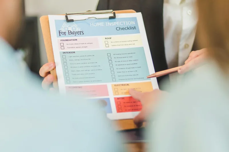 Checklist of real estate VA tasks on a clipboard with agent&rsquo;s desk in background