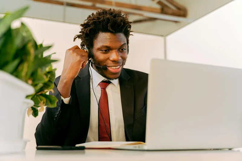 Virtual assistant professional in a headset on a client video call, managing communication and building relationships