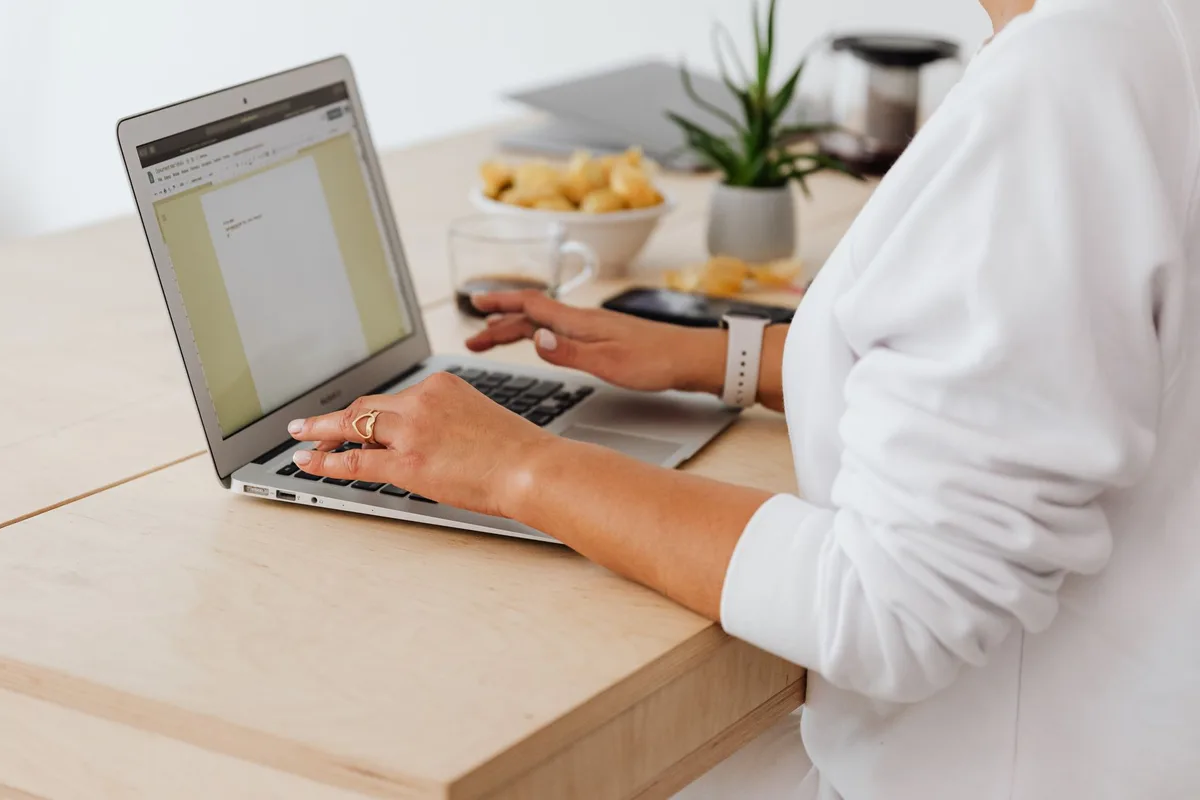 Woman working professionally on laptop at home, the foundation of starting a virtual assistant business