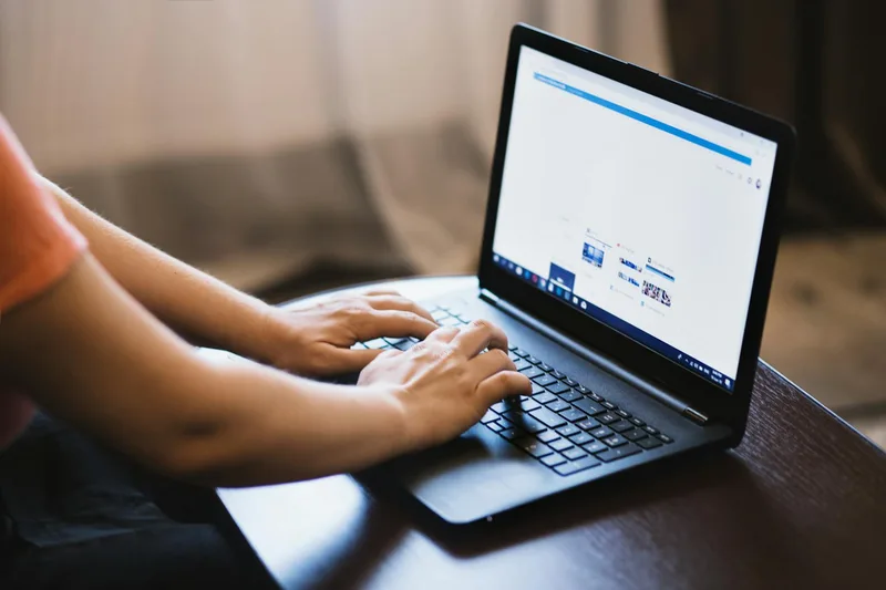 Close-up of a laptop screen showing remote job listings, representing online VA job boards