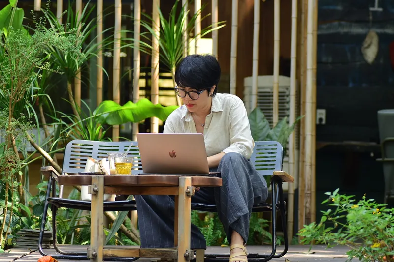 A Pinterest VA working remotely from a laptop, reaching out to potential clients