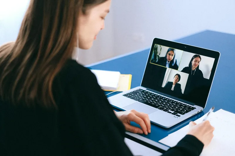Person preparing for a remote job interview on a video call with a professional home background