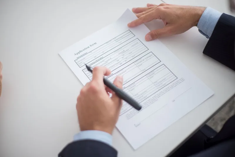 Hiring manager reviewing job applications at desk