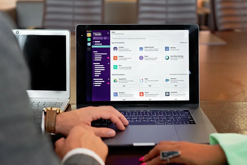 Two professionals using communication software during a business meeting