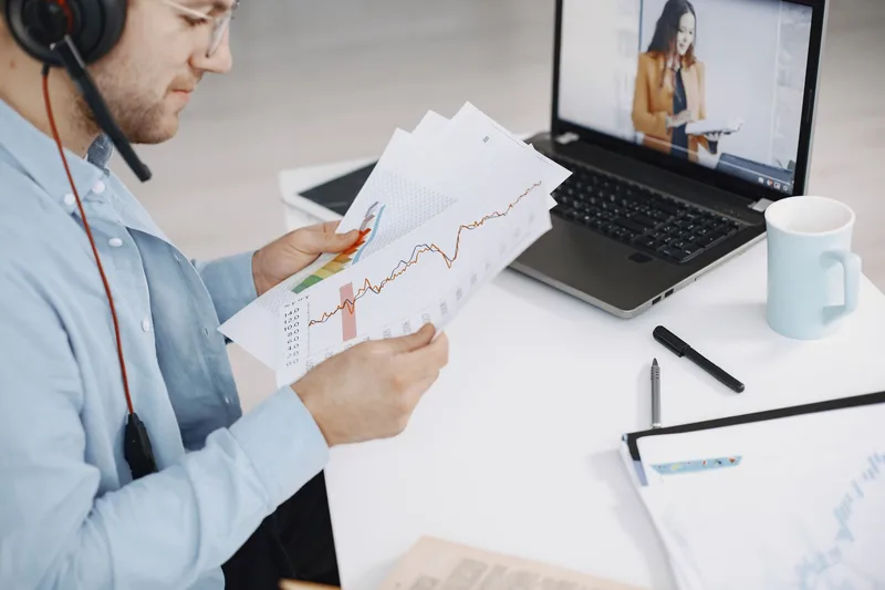 A person on a video call from a home office, talking with a client