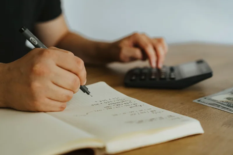 Solopreneur calculating weekly delegable hours to size a virtual assistant package