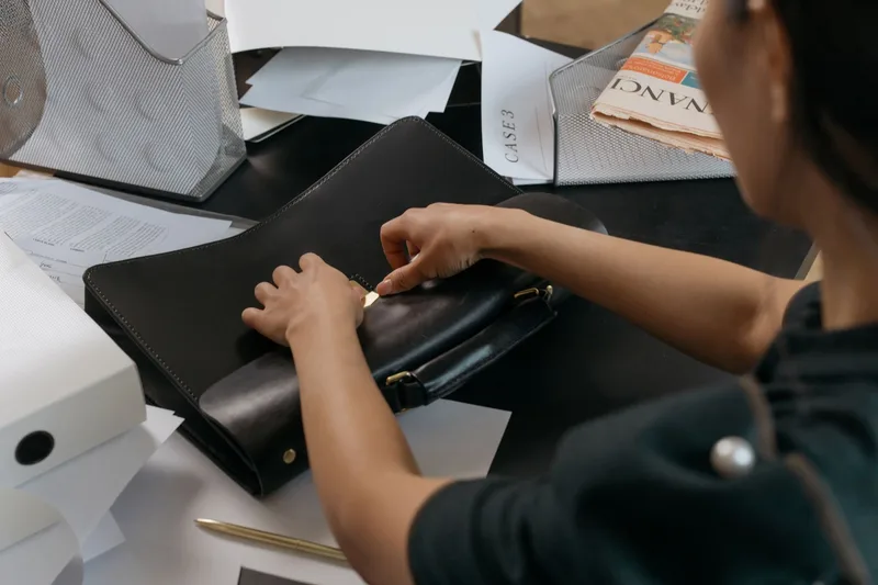 Organized work documents and a laptop on a professional desk
