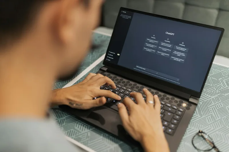 Virtual assistant using AI tools and automation software on dual monitor setup