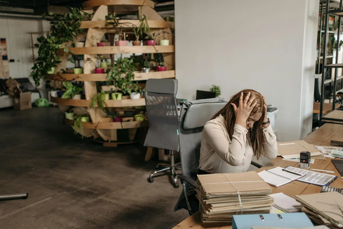 Business owner at desk with multiple browser tabs open, overwhelmed by task backlog
